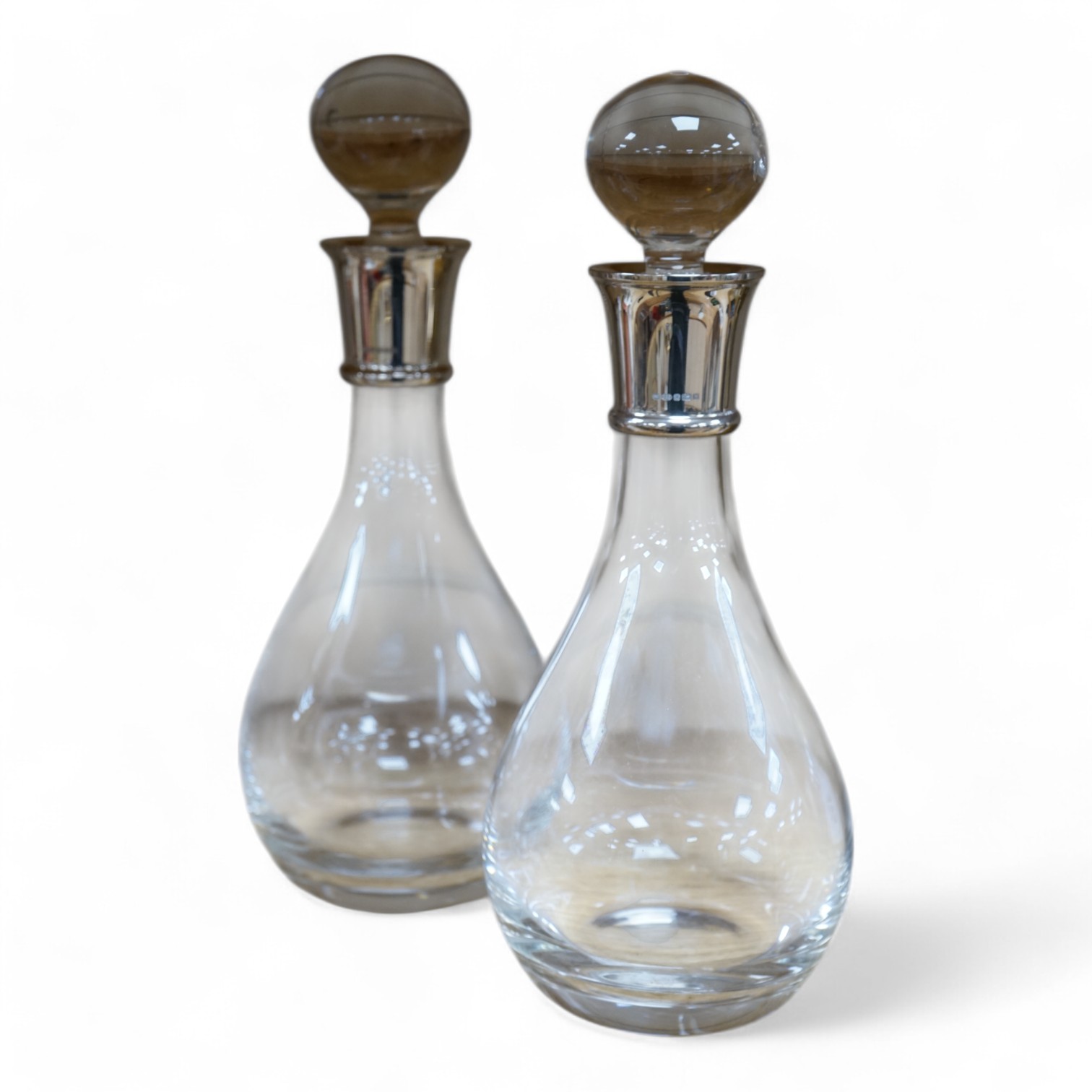 A pair of modern silver collared glass decanters and stoppers, 31cm. Condition - fair to good